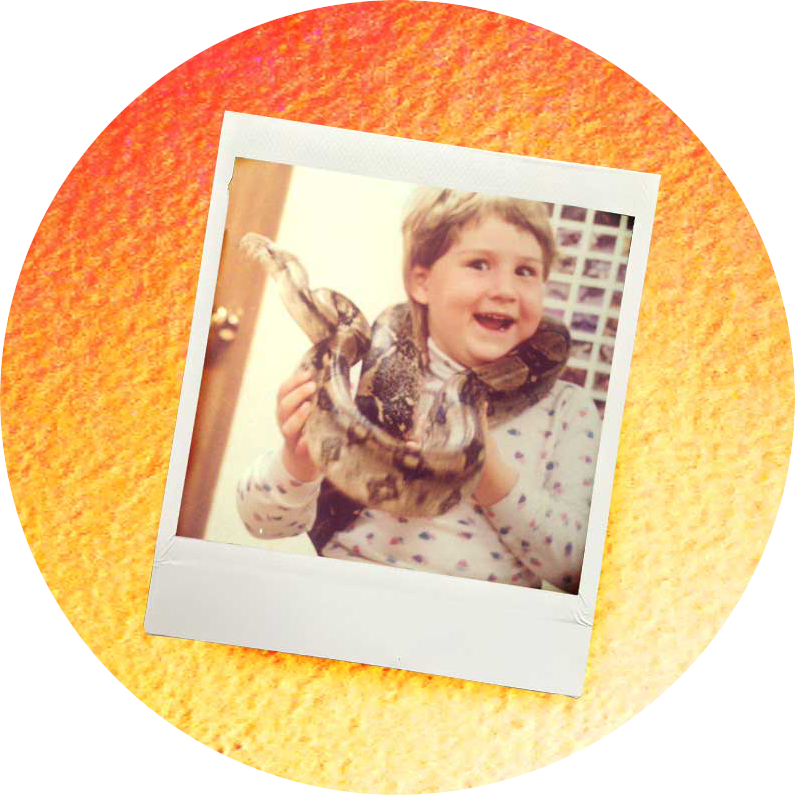 polaroid of a 7 year old girl with a blonde mullet and a HUGE grin, holding a python wrapped around her neck with on a gradient orange to yellow background